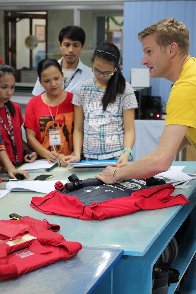 Spinlock's Myles Uren demonstrates the assembly of the lifejacket at the factory. © Spinlock